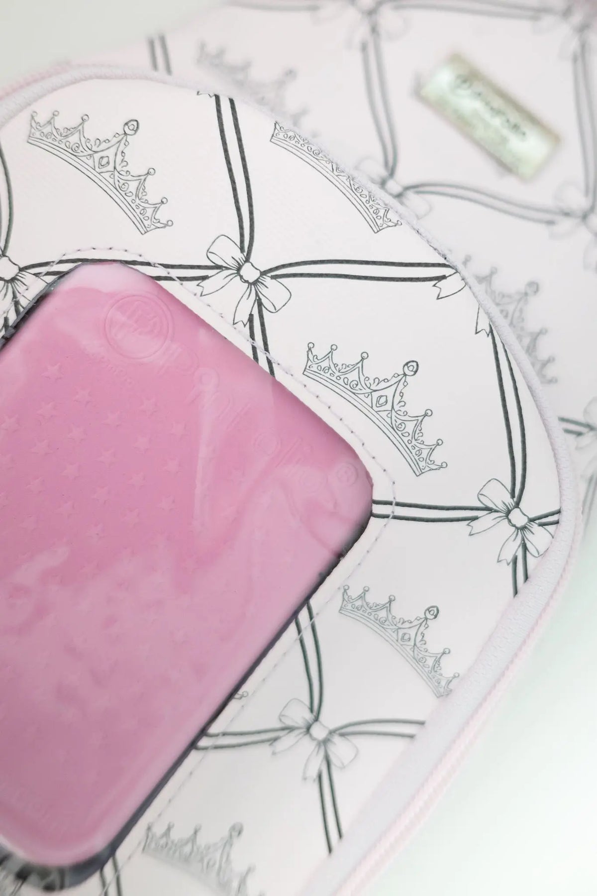 Close-up of the PinFolio® Sling Bag Crown print and front window