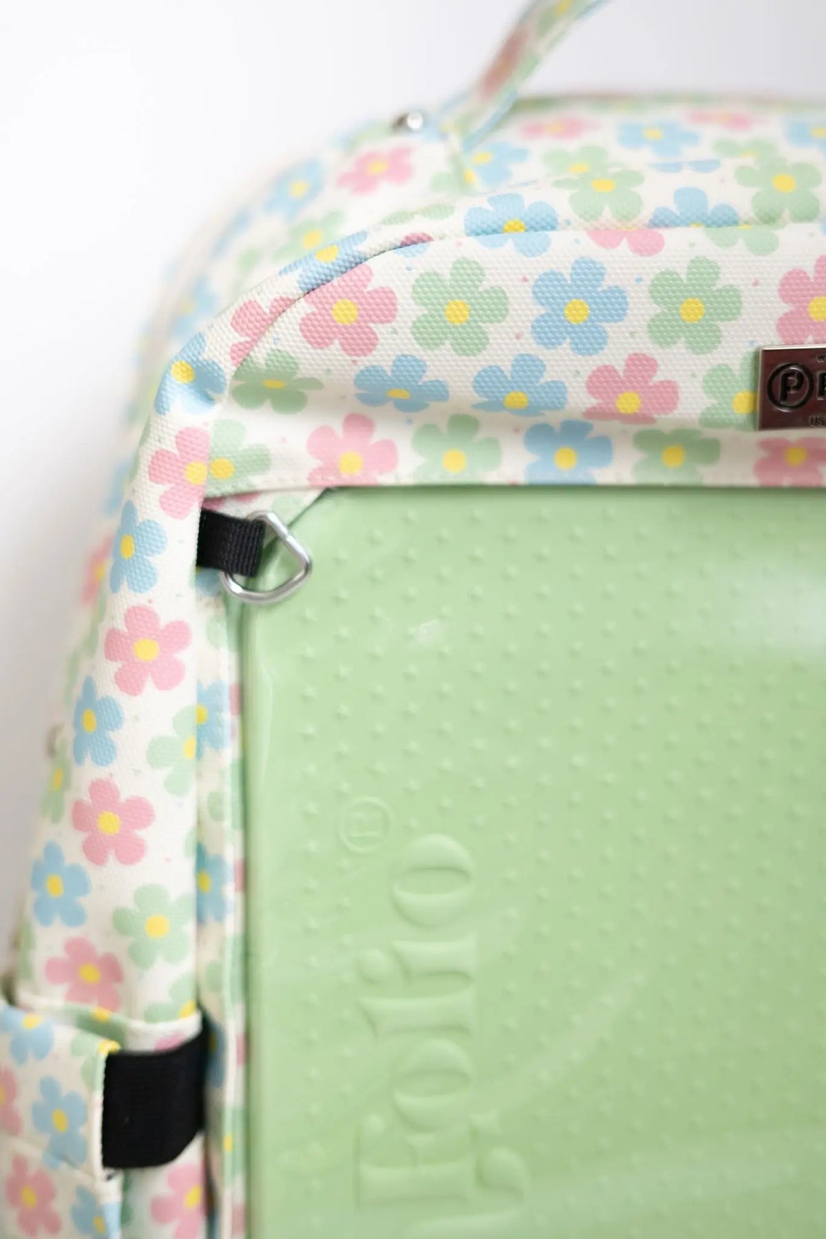Close-up of the PinFolio® Backpack Daisy print corner and zipper